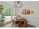 The bright dining room has a view to the backyard and unique decor on the wall at 120 E Laurenbrook Ct, Cary, NC 27518
