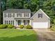Charming two-story home featuring a well-manicured lawn and attached two-car garage at 120 E Laurenbrook Ct, Cary, NC 27518