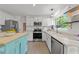 The bright kitchen features stainless steel appliances and a functional island for extra space at 120 E Laurenbrook Ct, Cary, NC 27518