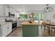 Bright kitchen features stainless appliances, a wooden island, and a view of the wooded backyard at 120 E Laurenbrook Ct, Cary, NC 27518