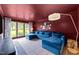Bright living room with a plush blue sofa, large windows, and tasteful decor at 120 E Laurenbrook Ct, Cary, NC 27518