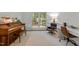 Well-lit office space featuring a comfortable reading chair, piano, and large windows at 120 E Laurenbrook Ct, Cary, NC 27518