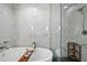Luxurious bathroom featuring a soaking tub, marble tile surround, and separate glass-enclosed shower at 122 N Harrington St # 1025, Raleigh, NC 27603