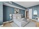 Stylishly designed bedroom with sleek white bed frame, modern decor, and elegant blue textured walls at 122 N Harrington St # 1025, Raleigh, NC 27603