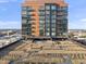 Exterior of a modern brick building featuring balconies, with a roof terrace and city views at 122 N Harrington St # 1025, Raleigh, NC 27603
