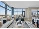 Bright, spacious living room features expansive windows with city views and modern decor at 122 N Harrington St # 1025, Raleigh, NC 27603