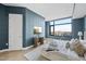 Serene main bedroom with blue accent wall and expansive windows showcasing stunning cityscape views at 122 N Harrington St # 1025, Raleigh, NC 27603