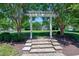 Arbor with stone steps leading to lawn at 129 Middlegreen Pl, Holly Springs, NC 27540