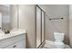 Bathroom featuring a white vanity with drawers and a tiled walk-in shower at 129 Middlegreen Pl, Holly Springs, NC 27540