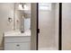Bathroom featuring vanity and walk-in tiled shower with a window at 129 Middlegreen Pl, Holly Springs, NC 27540