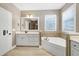 Bathroom with tile flooring, white vanity and tub with tile surround at 129 Middlegreen Pl, Holly Springs, NC 27540