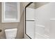 Bright bathroom features a tiled shower, glass door, and adjacent toilet at 129 Middlegreen Pl, Holly Springs, NC 27540