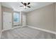 Neutral bedroom includes carpet, ceiling fan, window bench, and closets at 129 Middlegreen Pl, Holly Springs, NC 27540