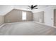 Bright bedroom offers soft carpet, a ceiling fan, and natural light at 129 Middlegreen Pl, Holly Springs, NC 27540