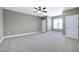 Spacious bedroom with soft carpet, multiple windows, and neutral wall color at 129 Middlegreen Pl, Holly Springs, NC 27540