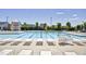 View of the refreshing community pool with lounge chairs and umbrellas for residents at 129 Middlegreen Pl, Holly Springs, NC 27540
