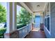 View from covered porch with brick columns and a white railing offering a peaceful outdoor space at 129 Middlegreen Pl, Holly Springs, NC 27540