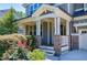 Inviting front porch with brick accents and lush landscaping, perfect for relaxing and enjoying the outdoors at 129 Middlegreen Pl, Holly Springs, NC 27540