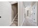 Hallway view featuring carpeted stairs and doorways leading to other rooms at 129 Middlegreen Pl, Holly Springs, NC 27540