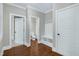 Hallway featuring wood floors with access to bathroom, closet and other living areas at 129 Middlegreen Pl, Holly Springs, NC 27540