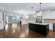 Spacious kitchen with a large island, stainless steel appliances, and seamless flow into the living area at 129 Middlegreen Pl, Holly Springs, NC 27540