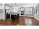 Spacious kitchen features stainless steel appliances, white cabinetry, and a dark island with granite countertop at 129 Middlegreen Pl, Holly Springs, NC 27540