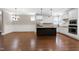 Open concept kitchen with an island, stainless steel appliances, and white cabinets for a modern look at 129 Middlegreen Pl, Holly Springs, NC 27540