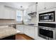 Well-appointed kitchen featuring modern appliances, light countertops, and ample cabinet space for storage at 129 Middlegreen Pl, Holly Springs, NC 27540