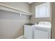 Laundry room with washer, dryer, utility shelf and window at 129 Middlegreen Pl, Holly Springs, NC 27540