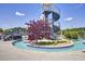 A lazy river winds around a slide structure and lush landscaping, inviting relaxation at 129 Middlegreen Pl, Holly Springs, NC 27540