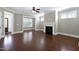 Open-concept living area with fireplace, hardwood floors, and large windows creating a comfortable space at 129 Middlegreen Pl, Holly Springs, NC 27540