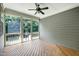 Relaxing screened porch with wood flooring and fan offers a peaceful outdoor space at 129 Middlegreen Pl, Holly Springs, NC 27540
