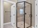 Glass shower with seating, updated fixtures, and tile surround at 129 Middlegreen Pl, Holly Springs, NC 27540