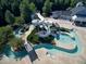 Aerial view of waterpark with slides, lazy river, and adjacent buildings for residents at 129 Middlegreen Pl, Holly Springs, NC 27540