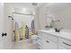 Modern bathroom featuring a stylish shower curtain and a clean, white vanity with black hardware at 1313 Littlehills Dr, Apex, NC 27523