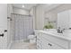 Bright bathroom featuring a white vanity with modern fixtures and decorative shower curtain at 1313 Littlehills Dr, Apex, NC 27523