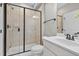 Modern bathroom features a glass-enclosed shower with sleek fixtures and a spacious white sink vanity at 1313 Littlehills Dr, Apex, NC 27523