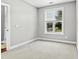 Clean, carpeted room with a large window offering a view of the residential neighborhood at 1313 Littlehills Dr, Apex, NC 27523