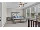 Spacious bedroom with large windows, a ceiling fan, and stylish furniture, creating a serene atmosphere at 1313 Littlehills Dr, Apex, NC 27523