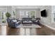 Comfortable living room featuring hardwood floors, a large window, and contemporary furnishings at 1313 Littlehills Dr, Apex, NC 27523