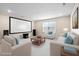 Entertainment area with white seating, home theatre, and large, bright window at 1313 Littlehills Dr, Apex, NC 27523