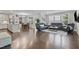 Spacious living room connected to kitchen and dining with lots of natural light and hardwood flooring at 1313 Littlehills Dr, Apex, NC 27523