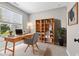 Inviting home office boasts a wooden desk, a comfortable chair, and a charming bookcase with curated decor at 1313 Littlehills Dr, Apex, NC 27523