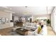 Open-concept living room connected to kitchen and dining area, furnished with modern decor and plenty of sunlight at 135 Gary Rd, Carrboro, NC 27510