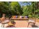 Inviting back deck features a stylish swing, outdoor rug, and comfortable seating perfect for relaxing in nature at 1409 Valley, Durham, NC 27707