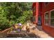 Spacious back deck features stylish furniture, outdoor dining, and a lush view of the surrounding greenery at 1409 Valley, Durham, NC 27707