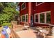The back deck features a seating area that complements the house's red exterior and serene, wooded backyard at 1409 Valley, Durham, NC 27707