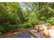 The expansive back yard boasts mature trees and a wooden deck with seating, creating a peaceful outdoor retreat at 1409 Valley, Durham, NC 27707