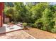 This spacious backyard features brick and wood patios and mature trees, creating a serene outdoor retreat at 1409 Valley, Durham, NC 27707