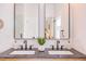 Close-up of a modern bathroom vanity with double sinks, stylish fixtures, and a clean, minimalist design at 1409 Valley, Durham, NC 27707